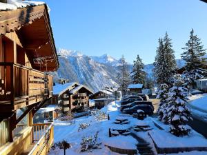 une ville enneigée avec une montagne en arrière-plan dans l'établissement Duplex central à Courchevel avec cheminée, balcon, et WIFI - FR-1-575-147, à Courchevel