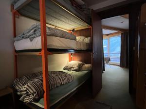 a bunk bed room with two bunk beds in it at Résidence Bero Bisto - maeva Home - Appartement 2 pièces 6 personnes - Confort MAE-1931 in La Mongie