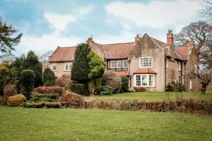 an old house with a garden in front of it at Gallows Hill in Scarborough