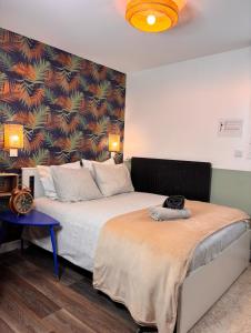 a bedroom with two beds and a wall with a mural at Cosy Home Next To Disneyland & Train in Torcy