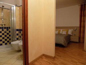 a bathroom with a bed and a bathroom with a shower at B&B Locanda Del Mulino in Pamparato +23 photos