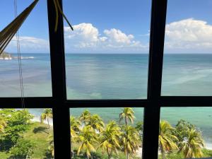 a view of the ocean from a window at Estudio con Increíble VISTA AL MAR de 1 a 4 huespedes in Porlamar