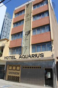 a hotelaquarius building on the corner of a street at Hotel Aquarius in Coronel Fabriciano