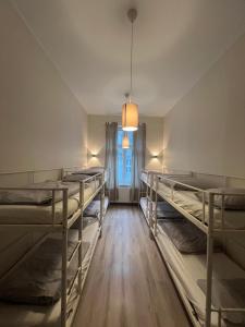 a room with several bunk beds and a window at Fox hostel in Krakow