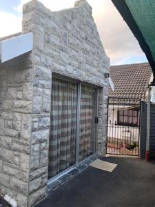 a stone building with a gate in front of it at Ahava Accommodation in Scottburgh