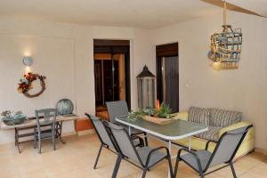 a dining room and living room with a table and chairs at Stergios Garden House in Kalabaka