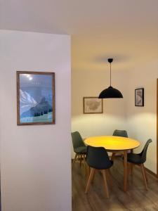 a dining room with a yellow table and chairs at Ferienwohnung Eulennest in Bolsterlang