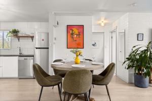 a kitchen and dining room with a table and chairs at Bayswell by Experience Jervis Bay in Huskisson +16 photos