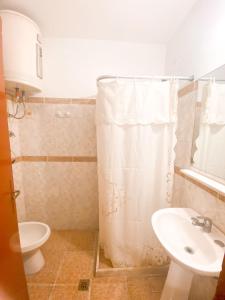 a bathroom with a toilet and a sink at Hotel Centro in Piriápolis +35 photos
