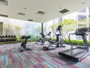 a gym with several exercise bikes in a room at Signature Apartment at Mercu Summer Suites KLCC in Kuala Lumpur