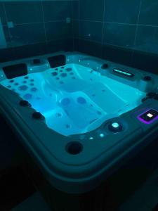 a jacuzzi tub with blue lights in a bathroom at Jacuzzi privé 500m de la mer in Blainville-sur-Mer