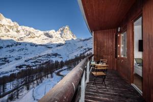 a balcony with a view of a snow covered mountain at Erikzang - Cervinia Ski in Ski out Apartments in Breuil-Cervinia