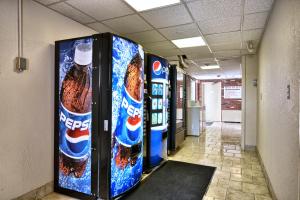 a couple of soda machines in a hallway at Howard Johnson by Wyndham Bangor in Bangor