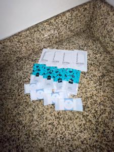 two rolls of toilet paper on a floor with papers at Budget Inn Ada in Ada