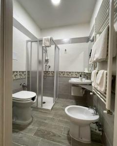 a bathroom with a toilet and a sink and a shower at B & B Ai Giardinetti in SantʼArsenio +16 photos