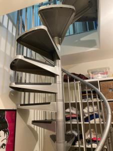 a spiral staircase with a light on the top at Alexis 3 in Novara