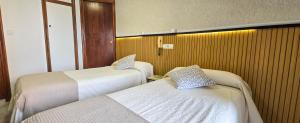 a hotel room with two beds in a room at Hostal Ramón y Cajal in Valladolid