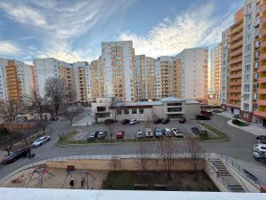 a parking lot in a city with tall buildings at For Family Full Apartment near AirPort in Chişinău