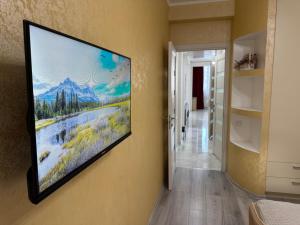 a flat screen tv hanging on a wall at For Family Full Apartment near AirPort in Chişinău