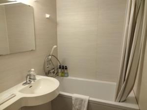 a bathroom with a sink and a shower and a tub at Hotel Hanakomichi - Vacation STAY 27567v in Nara