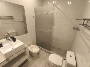 a bathroom with a sink and a toilet and a shower at Céntrika in Mendoza +6 photos