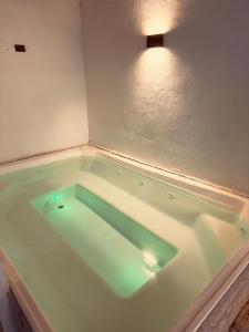 a bath tub with a light in a room at Casa Provenza in Medellín