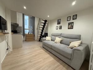 a living room with a couch and a television at Studio Roma - Jean Médecin - LA RIVIERA LCD in Nice