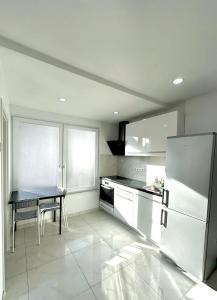 a kitchen with a table and a refrigerator at Apartment in Waldbronn