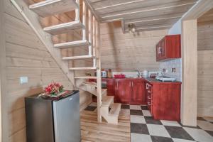 a kitchen with a spiral staircase in a cabin at Domek NBD-bafia in Zakopane