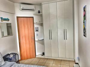 a bedroom with a closet and a bed and a door at Fabinhos SSA in Salvador +18 photos