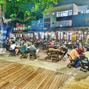 a group of people sitting in chairs at tables at Fabinhos SSA in Salvador