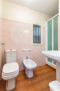 a bathroom with a toilet and a sink at C22 Beachfront Villa - SPA BATH, POOL, PRIVATE BEACH, PARKING FREE in Marina dʼAndora