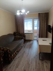 a living room with a couch and a table at Apartments near the Trinity Church on Dovzhenko Street,102 in Chernihiv