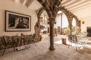 a room with a table and chairs in a building at Casa Clara by Ananay Hotels in Cusco