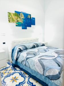 a bedroom with a bed with a blue comforter at Ruggiero house Pompei in Pompei