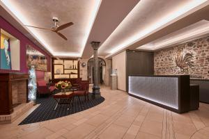 a lobby with a waiting area with a table and chairs at Hotel d'Allèves in Geneva