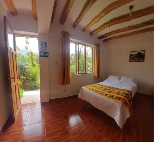 A bed or beds in a room at Hostal Miramonti