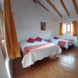 A bed or beds in a room at Hostal Miramonti
