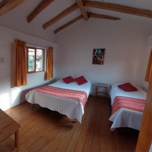 A bed or beds in a room at Hostal Miramonti