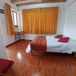 A bed or beds in a room at Hostal Miramonti