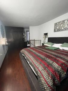 a bedroom with a large bed with a colorful blanket at CasaHappy Deluxe in El Suazal