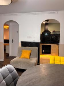 a living room with a couch and a yellow pillow at Cosy Home Next To Disneyland & Train in Torcy +45 photos