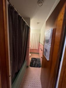 a room with a bathroom with a shower curtain at Charming Cape Cod Bungalow at Niagara Falls, NY! in Niagara Falls