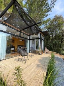 a pavilion with two chairs on a wooden deck at Container Dos Sonhos in Rio Forcação