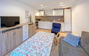 a living room with a couch and a kitchen at Ferienwohnung Waren Müritz in Waren
