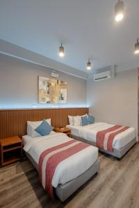 Postel nebo postele na pokoji v ubytování Kekehyu Business Hotel