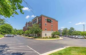 a parking lot in front of a brick building at Extended Stay America Suites - Washington, DC - Fairfax - Fair Oaks Mall in Fairfax