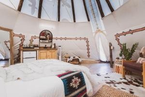 a bedroom with a large bed in a room with windows at Toro Tipi at El Mistico Ranch in Nogal