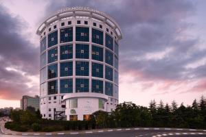 a tall white building with a sign on it at Delta Hotels Istanbul West in Istanbul