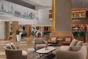 a lobby with chairs and tables and a bar at Delta Hotels Istanbul West in Istanbul +28 photos